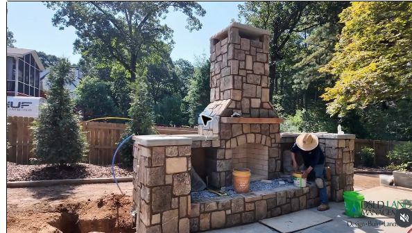 Custom stone fireplace under construction at DSLD's Birmingham outdoor retreat project